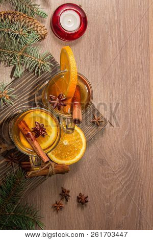 Two Glasses With Delicious Fragrant Tea Of Mulled Wine With Orange And Spices On A Wooden Board With