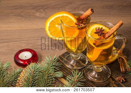 Two Glasses With Delicious Fragrant Tea Of Mulled Wine With Orange And Spices On A Wooden Board With