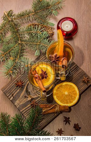 Two Glasses With Delicious Fragrant Tea Of Mulled Wine With Orange And Spices On A Wooden Board With