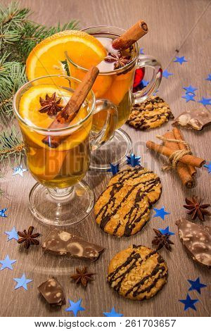 Two Glasses With Delicious Fragrant Tea Of Mulled Wine With Orange And Spices On A Wooden Board With