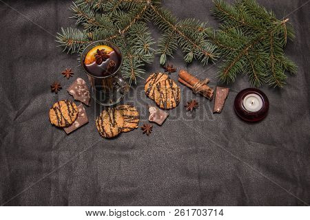 A Glass Of Flavored Mulled Wine On A Black Leather Background With Biscuits Pieces Of Chocolate Chop