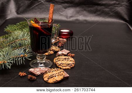 A Glass Of Flavored Mulled Wine On A Black Leather Background With Biscuits Pieces Of Chocolate Chop