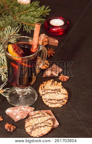 A Glass Of Flavored Mulled Wine On A Black Leather Background With Biscuits Pieces Of Chocolate Chop
