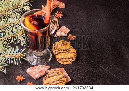 A Glass Of Flavored Mulled Wine On A Black Leather Background With Biscuits Pieces Of Chocolate Chop