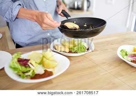 Female Hands, Black Frying Pan, Boiled Potatoes, Green Salad, Meat Cutlet With Cheese, White Ceramic