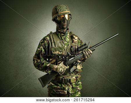 Soldier agent in a dark room with arms on his hand and gas mask