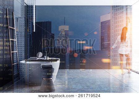 Side View Of Luxury Bathroom With Gray Tile Walls, Concrete Floor, White Bathtub And Wooden Ladder I