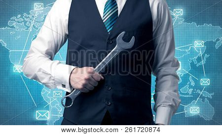 Businessman holding tool with global map graphic on the background