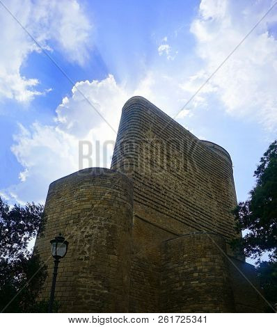 Baku Maiden Tower Back View At Noon Time With Awesome Cloudy Blue Sky Background