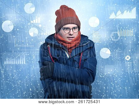 Young businessman shivering with graphs, reports and chart concept