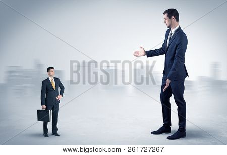 Giant businessman being afraid of small serious executor with suitcase