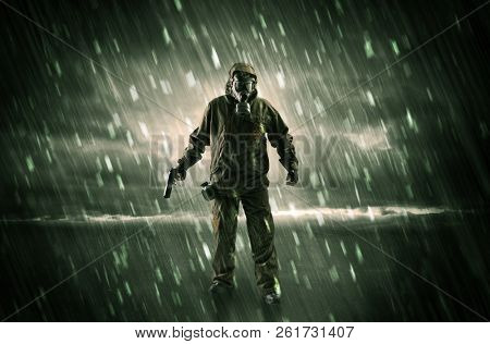 Terrorist in a stormy space with gas mask on his hand and weapons on his arm