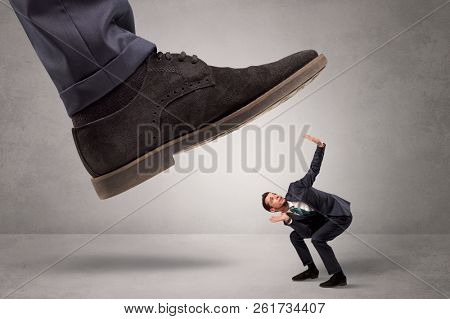Young businessman illustrated inconsiderable by being trampled