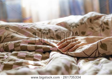 Close Up Young Sick Male Hand Lying In Bed While Strugle With Ilness