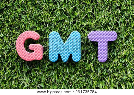 Color Alphabet Letter In Word Gmt (abbreviation Of Greenwich Mean Time) On Artificial Green Grass Ba