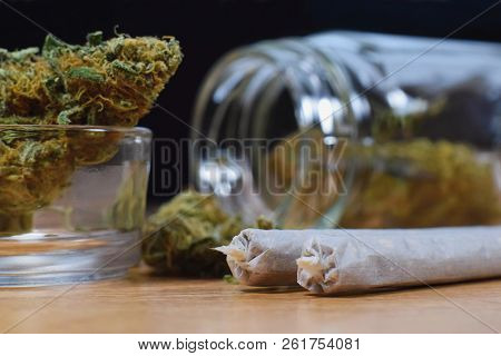 Marijuana Buds, Jar, Money And Joints On The Table