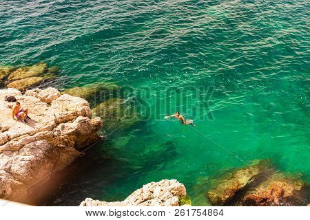 Nice, France - 2018.
Young Boys Swimming Close To The Rock In Nice, France.
