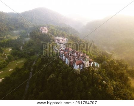 Aerial View Of French Style Building At Bukit Tinggi With Dramatic Fog And Sunrise.