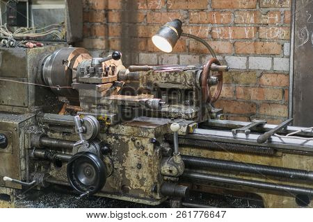 Old Machinery In A Factory From The Mid-20th C. Working Machine-tool. Old Lathe.