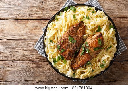 New Orleans Chicken Lazone Fried With Spices And Fettuccine Pasta In A Creamy Sauce Close-up. Horizo