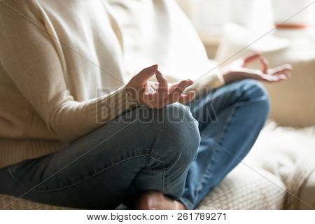 Senior Woman Holding Hands In Mudra Practicing Home Yoga, Closeu