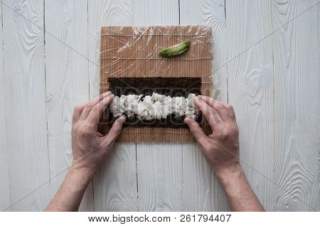 Process Of Making Maki Sushi. Cook Chef Hands Preparing Rolls With Cheese, Avocado And Sesame Seeds 