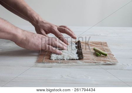 Process Of Making Maki Sushi. Cook Chef Hands Preparing Rolls With Cheese, Avocado And Sesame Seeds 