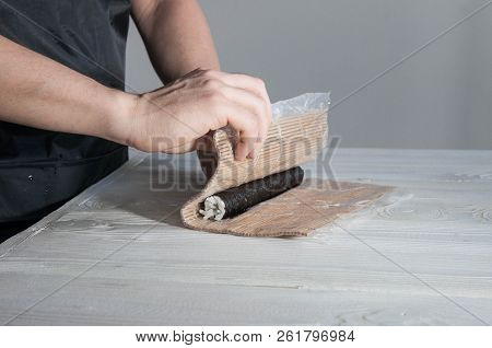 Process Of Making Maki Sushi. Cook Chef Hands Preparing Rolls With Cheese, Avocado And Sesame Seeds 