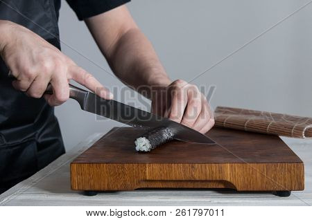 Process Of Making Maki Sushi. Cook Chef Hands Preparing Rolls With Cheese, Avocado And Sesame Seeds 