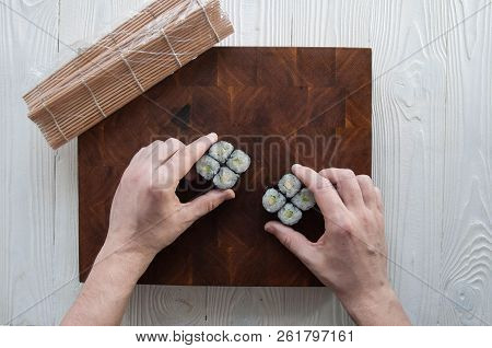 Process Of Making Maki Sushi. Cook Chef Hands Preparing Rolls With Cheese, Avocado And Sesame Seeds 