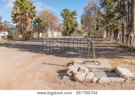 Loxton, South Africa, August 7, 2018: A Street Scene, With An Historic Hand-operated Water Pump, In 