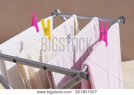 Fresh Clean Towels Drying On Washing Line Outdoor. Laundry Hangs On The Dryer. Drying Clean Clothes 