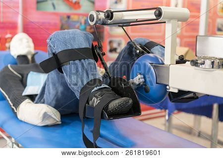 Simulator For Leg Rehabilitation. Rehabilitation Of Injured Limbs. Mannequin In The Apparatus For Tr