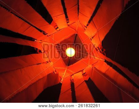 Vibrant Saffron Red Kandeel Lantern With Incandescent Lamp Inside Lantern Visible With Central Symme
