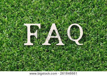 Wood Letter In Word Faq (abbreviation Of Frequently Asked Questions) On Artificial Green Grass Backg