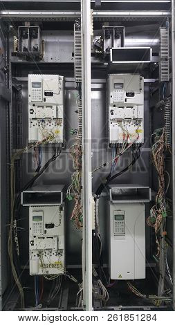 Electrical Parts And Mechanical Parts On Big Gear And Drum Rolls On White Floor