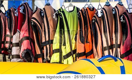Life Jackets Hanging On Clothes Line. Buoyancy Jackets On A Rail, Used When Hiring A Jet Ski