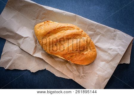 White Bread Rolls On Crafting Wrapping Paper On A Dark Table Background.