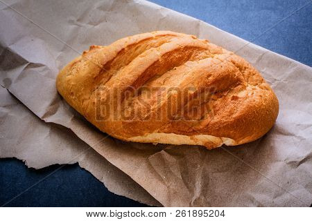White Bread Rolls On Crafting Wrapping Paper On A Dark Table Background.