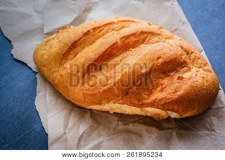 White Bread Rolls On Crafting Wrapping Paper On A Dark Table Background.