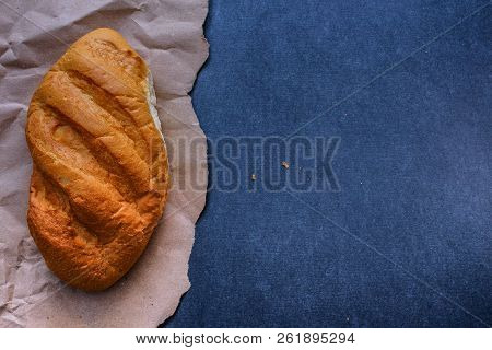 White Bread Rolls On Crafting Wrapping Paper On A Dark Table Background.