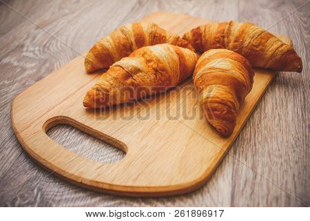 A Rich Variety Of Food Photography Croissant.
Four Croissants On A Wooden Light Cutting Board On A W