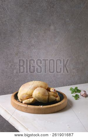 Raw Organic Uncooked Whole Yellow Corn Mini Chicken On Wooden Cutting Board With Salt, Herbs And Gar