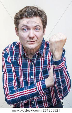 Portrait Of Young Funny Venturesome Man Showing Hand Sign Obscene Gesture The Fist On White Backgrou