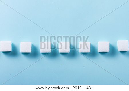 Sugar Cubes Row On Blue Background, Flat Lay Scene
