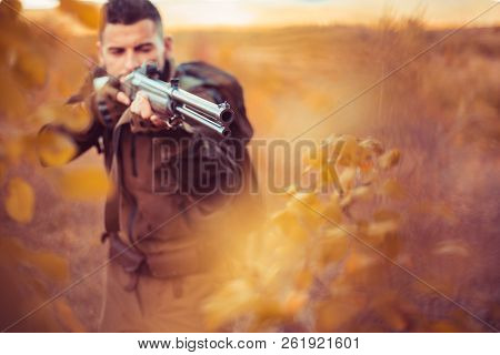 Autumn Hunting Season. Hunter Aiming Rifle In Forest. Barrel Of A Gun