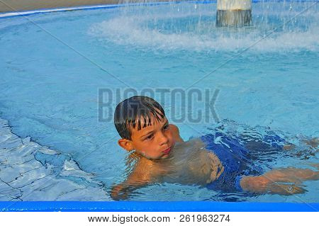 Cute Little Boy In The Public Swimming Pool. Portrait Of Little Cute Boy In The Swimming Pool. Sunny