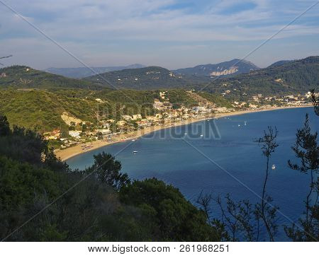 Panoramic View Of Agios Georgios Pagon Sand Beach With Green Hills And Sailing Ships At Corfu Island