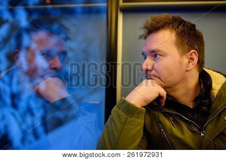Man Looking Out Of The Window Of Train During Travel On Cogwheel Railway/rack Railway In Alps Mounta