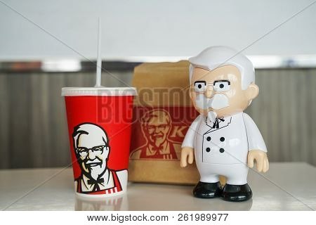Bangkok ,thailand- September 15,2018: Colonel Harland Sanders Statue Doll With Blurred Kfc Cold Drin